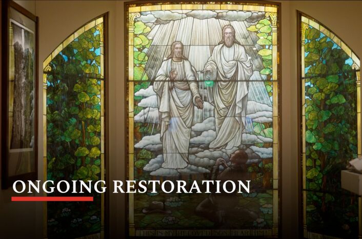 Stained glass window depicts the First Vision with the title “Ongoing Restoration” in the bottom left corner. 